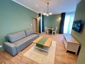 a living room with a couch and a table at Apartmány Lavender 