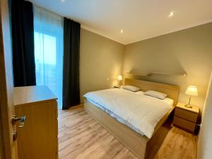a bedroom with a bed and a large window at Apartmány Lavender 