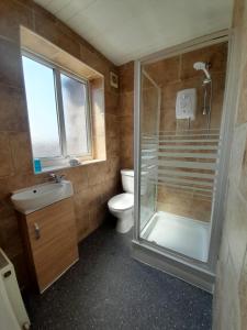 a small bathroom with a shower and a toilet at Church House in Gainsborough