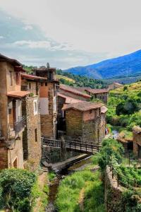 a group of buildings in a village with a river at Luna Menguante in Robledillo de Gata