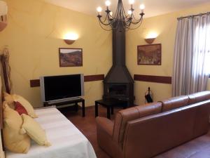a living room with a couch and a fireplace at Luna Menguante in Robledillo de Gata