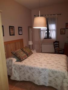 a bedroom with a bed with a pillow and a lamp at Luna Menguante in Robledillo de Gata +27 photos