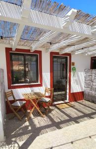 a patio with a table and chairs on a house at Cantinho de Milfontes 2 in Vila Nova de Milfontes +34 photos