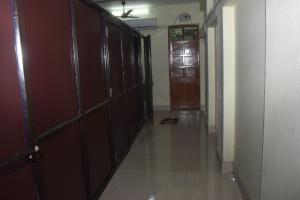 a hallway with wooden doors and a hallway with a door at JoyNest Guest House in Patna