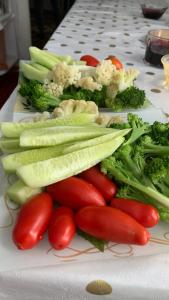 a white plate with vegetables on a table at Dan guest house in Pokrovka