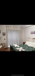 1 dormitorio con 1 cama con almohadas blancas en Spacieux Appartement à Porto en bord mer, en Póvoa de Varzim