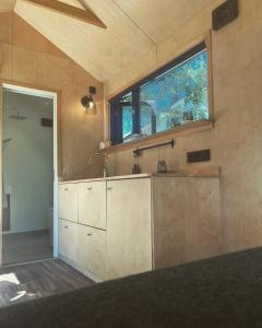 a kitchen with a sink and a window at Elevated Tiny House Glamping in Tjøme