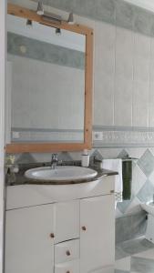 a bathroom with a sink and a mirror at CASA LAXE DO BARRO in Cangas de Morrazo