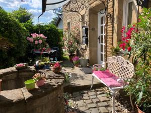 a garden with a chair and flowers in front of a house at Ferienwohnung im Grünen mit Balkon in Herdecke