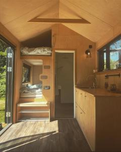 an interior view of a tiny house with a kitchen at Elevated Tiny House Glamping in Tjøme