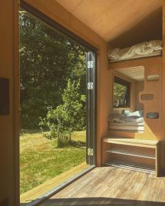 una puerta corredera de cristal de una casa con ventana en Elevated Tiny House Glamping, en Tjøme