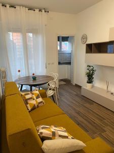 a living room with a couch and a table at SestoHome26 in Sesto San Giovanni