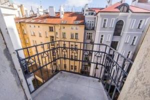a view of a city from a balcony of a building at Beautiful & peaceful apartment with cute balcony in Prague
