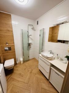 y baño con aseo, lavabo y ducha. en Apartament Neustettin-Polna Szczecinek, en Szczecinek