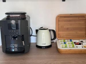 a coffeemaker and coffee maker sitting on a counter at Maurice en ville n14 in Namur