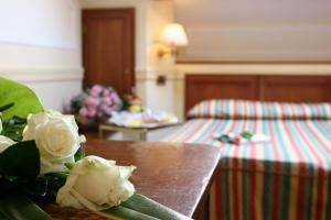 Postel nebo postele na pokoji v ubytování Hotel Arlecchino