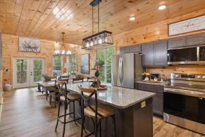 a kitchen with a large island with bar stools at Chasing the Son Cabin cabin in Sevierville