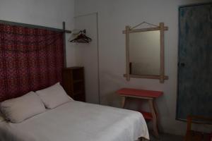 MONADita في سان كريستوبال دي لاس كازاس: غرفة نوم بسرير ومرآة وطاولة