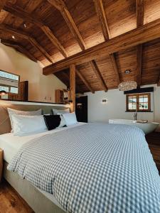 a bedroom with a large bed and a bath tub at Chalet Nordic mit privatem Whirlpool und Sauna in Bayrischzell
