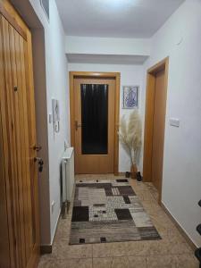 einen Flur mit Tür und Teppich auf dem Boden in der Unterkunft Apartman stan Konjic in Konjic