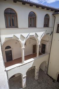 anterior view of a building with columns and windows at Tiny House Alferi in LʼAquila