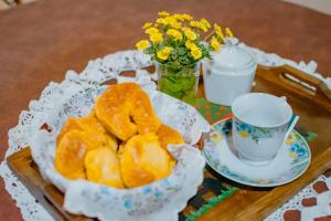 a table with a plate of doughnuts and a cup of coffee at Le Bon Repos in Alta Gracia