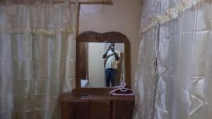 a man taking a picture of himself in a mirror at Annex House For Rent in Manjai Kunda