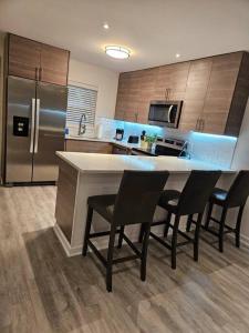 a kitchen with a table and chairs and a refrigerator at Midtown Atl Gem located 10 minutes from everything! in Atlanta