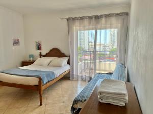 Ένα ή περισσότερα κρεβάτια σε δωμάτιο στο Rei Apartment