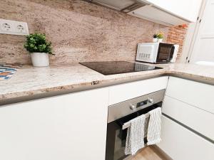a kitchen with a sink and a microwave at By Liceu Rooms in Barcelona