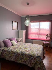 a bedroom with a bed and a window at Apartamento playa Vigo in Vigo