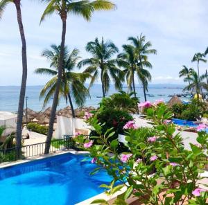 a view of the ocean from the balcony of a resort at one Beach st hotel - beach Front 2BD 2BA WITH BALCONY in Zona Romantic Puerto Vallarta in Puerto Vallarta