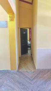 a room with a black door and a yellow wall at The Sea Breeze in Nuvem