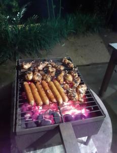 a grill with carrots and other food on it at Doranagala Holiday Home in Matale