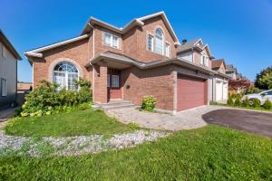 a brick house with a red garage at The house in Ottawa