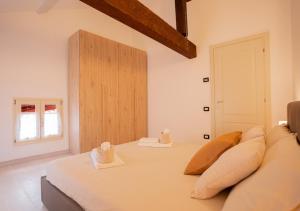a bedroom with a bed with pillows and a window at Mansarda Shakespeare - Car Parking in Ferrara