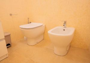 a bathroom with a toilet and a bidet at Mansarda Shakespeare - Car Parking in Ferrara +10 photos