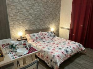 Un pequeño dormitorio con una cama y una mesa con platos. en RooMYitalia - Guest House Il Faraone, en Fiumicino