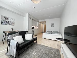 a living room with a couch and a bed at Transit Apartment HEL Airport in Vantaa
