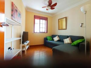 a living room with a couch and a ceiling fan at Casa Canillas - for solo travelers or small groups of 4 to 6 people in Canillas de Aceituno