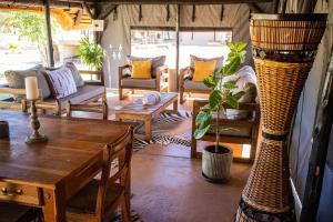 a living room with a table and chairs at Arnhem Cave Lodge in Omitara