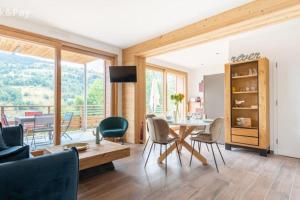 a living room with a table and chairs with a view at Appartement Maïnou à La Bresse in La Bresse