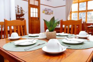 a wooden table with plates and napkins on it at 57 on Lorne Guesthouse in Estcourt