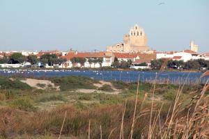 a view of a city and a river with a building at Maison au bord de mer in Saintes-Maries-de-la-Mer