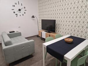 a living room with a table and a chair and a tv at A casa di Cippi in Rome