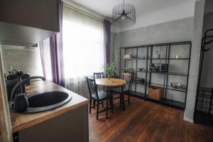 a kitchen with a table and a dining room at "Quiet Center" apartment, close to train station in Tukums