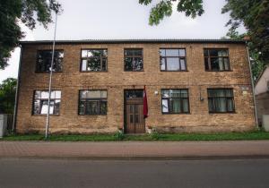 a brick building with a door and windows at "Quiet Center" apartment, close to train station in Tukums