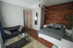 a bedroom with a bed and a couch at "Quiet Center" apartment, close to train station in Tukums