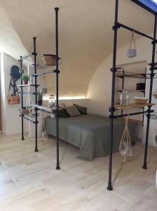 a bedroom with a bed and shelves in a room at Le studio de Diane - Terrasse et Parking - in Montboucher-sur-Jabron
