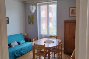 a living room with a table and a couch at Villa Véronique in Roquebrune-Cap-Martin